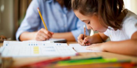 Mother helping daughter with homework